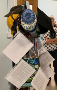 Cycling hats, William Hulme's school tie, hard hat, mortar board, field binoculars, Man City hat